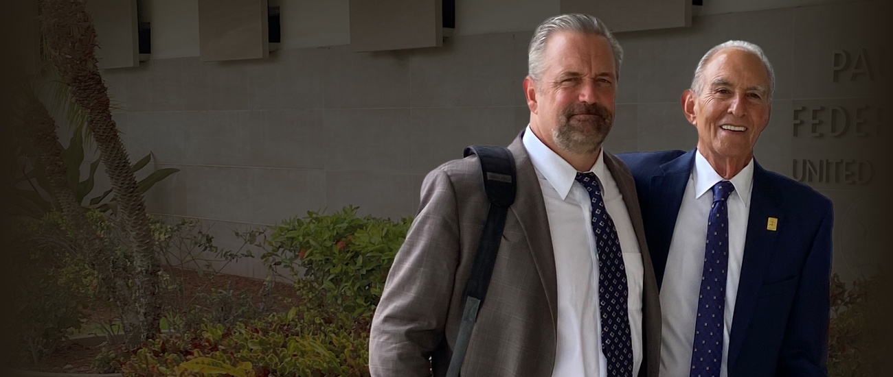 Philip C. Johnston and Glenn R. Roderman standing in front of a government building.